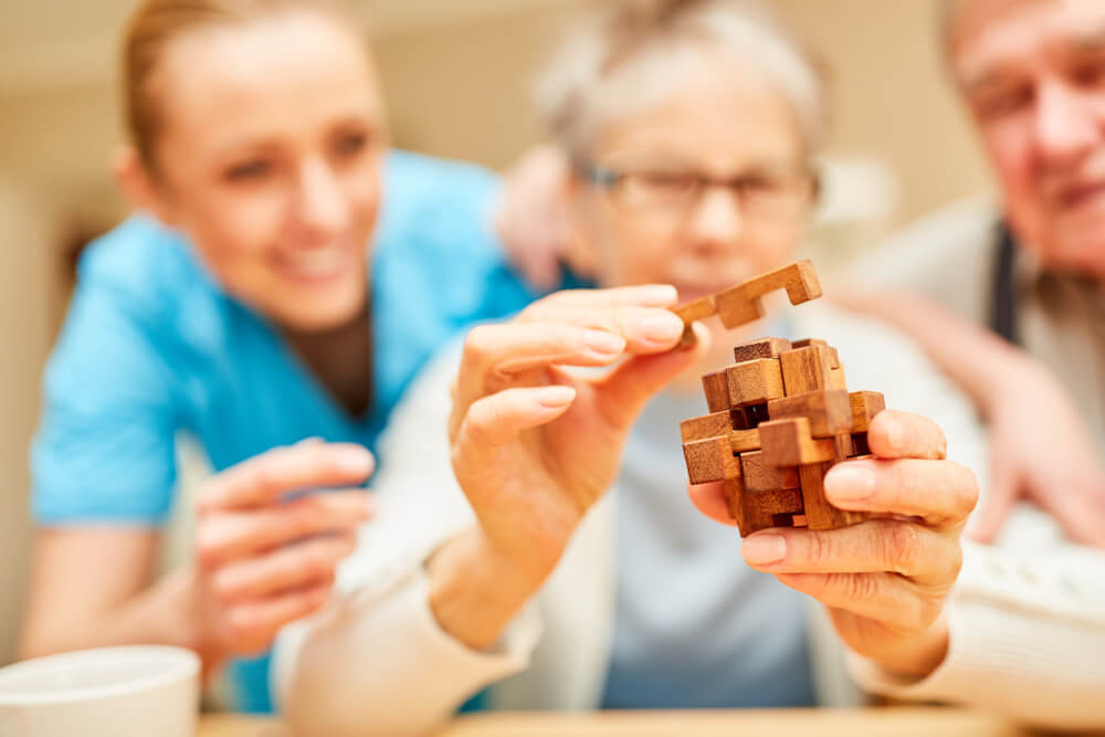 Demented,Senior,Woman,Puts,Blocks,Of,Wood,Together,In,The